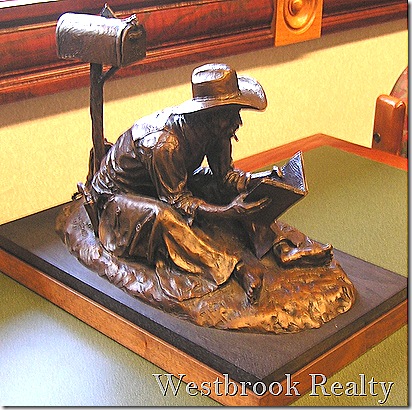 cowboy reader bronze sculpture